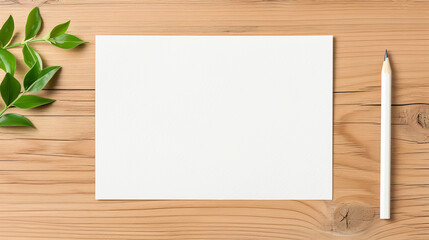 Naklejka premium Top view of blank white sheet of paper on wooden desk with pencil and green leaves, perfect for mockups, designs, and creativity.