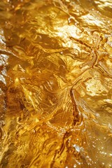 The image is of a gold colored liquid with ripples and waves. The water appears to be a deep shade of gold, and it seems to be reflecting light in a way that creates a shimmering effect