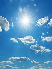 Bright Summer Sun Shining Through White Clouds in Blue Sky