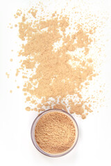 Face powder, material powder on a white background, material for make-up and female beauty, still life