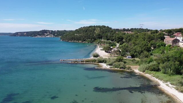 Aerial view drone video flying from the air over the picturesque sea coast of the south of France, Provence, Istres at bright sunny summer day