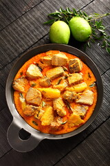 Top view- Asin fish curry cooked in iron wok.