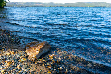 The coast of a beautiful mountain lake in the early morning.