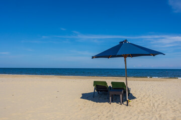 Blue umbrella and chair around beach sea ocean with blue sky for travel vacation