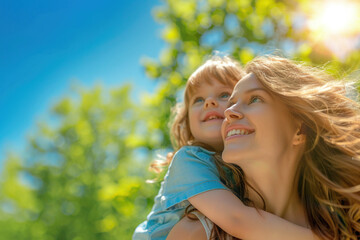 Fototapeta premium Mother and daughter enjoying a sunny day outdoors hugging piggyback. Single family bonding, love, and happiness concept. Parenting and childhood connection, family time