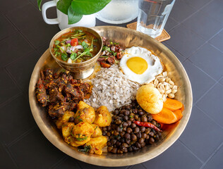 Newari Khaja Set Typical Nepali Thali with Rice Flakes, Choyila, Eggs, Chickpeas, Aalu Sadheko Lunch