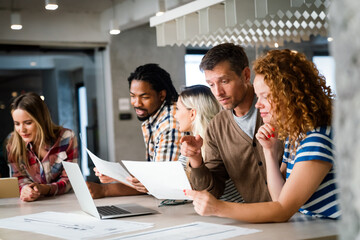 Successful multiethnic group of designers, architects, business people at work in office