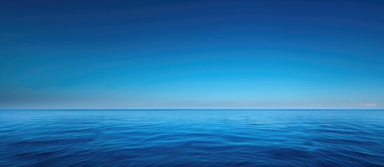 Bright Blue Morning Sky and Deep Indigo Ocean: A Serene Visual Encounter