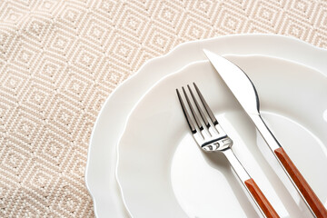 Empty plate with fork and knife on table