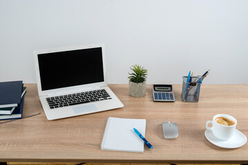 Desk for study work or freelance with note pad pen and laptop