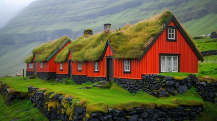 Red traditional scandinavian houses with grass on roof standing on green hill