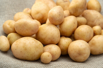 Close-up of fresh new potatoes on a jute mat.