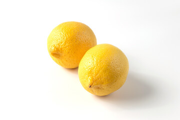 Ripe lemons on a white background