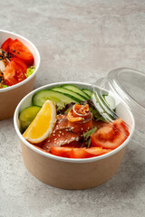 Tasty poke bowls on gray textured surface