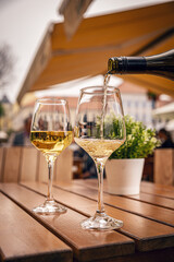 Glass is being filled with white wine