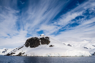 A tranquil Antarctic landscape, near Graham passage along Charlotte Bay, highlighting stark...