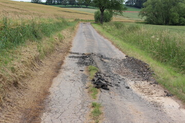 Image of a damaged asphalt road.