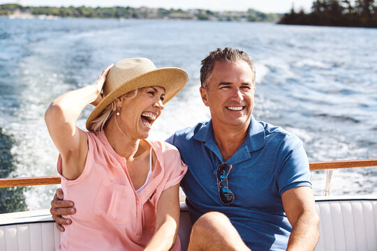Mature couple, happy and yacht cruise for relax, bonding and holiday on ocean together in retirement. Man, woman and smile on luxury boat at sea for love, vacation and romantic adventure in summer