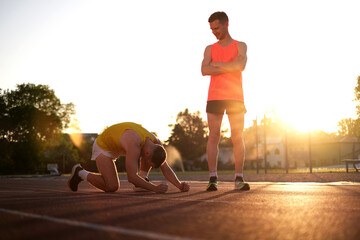 Very upset Losing athlete in a race at the stadium