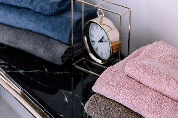 Spa, bathroom background. Stack of clean and folded towels. Bathroom and resort concept and interior accessories with copy space. Neutral beige colors.