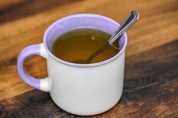 Herbata w kubku, łyżeczka dk herbaty w środku, słodzić herbatę koncept  © Paweł Kacperek