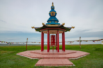 Buddhist gazebo with prayer drum in the steppe of Kalmykia. Russia
