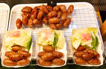 Fried sausages on a counter in a market