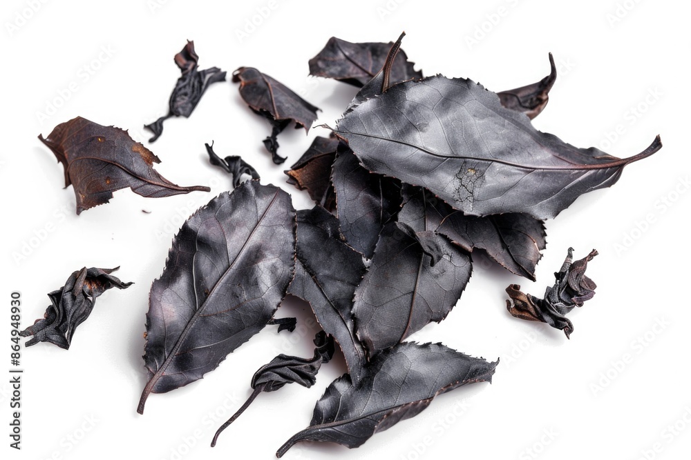 Poster a close-up view of a pile of black leaves on a white surface, perfect for use in designs and project