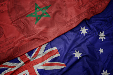 waving colorful flag of morocco and national flag of australia on the dollar money background. finance concept.
