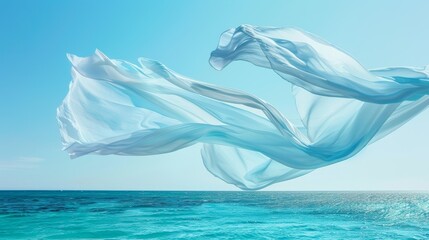 A light and airy cotton scarf gently moves above a serene ocean adding a touch of effortless elegance to the seascape.
