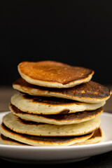 soft fresh pancakes and natural liquid honey in a wooden bowl