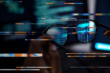 Closeup of a man holding a pair of glasses