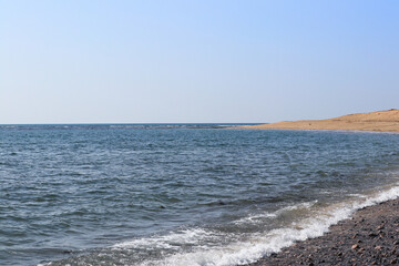 Seascape good clear blue sky and blue water island sunny. Sea wave slow water splash shore golden sandy beach summer. Travel tropical beach vacation relax seaside paradise. Mul Dwarka India Gujarat.