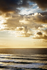 Seascape with large golden clouds at sunset. Tenerife, Spain.