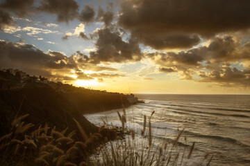 Seascape with large golden clouds at sunset. Tenerife, Spain.