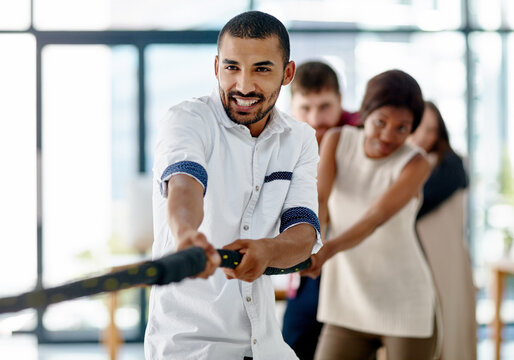 Leadership, tug of war and businessman in office for collaboration, together and competition. Team building, rope and people in global company with challenge, diversity and workforce in New York city