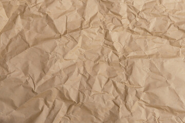 Overhead view of  crumpled brown paper in natural light.