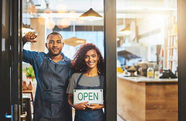Coffee shop, open sign and portrait of people for small business, teamwork and collaboration. Restaurant, hospitality and happy man and woman by cafeteria window for service, help and welcome