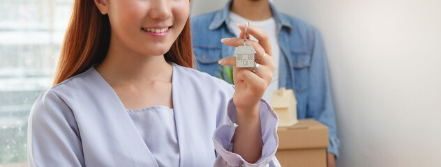 two people packing stuff into cardboard relocation to new apartment