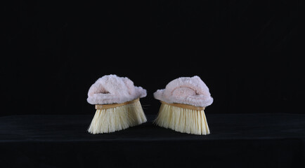 home slippers with brush isolated on black background