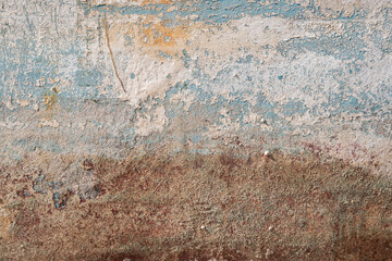Fragment of old weathered abandoned crumbling fishing boat body made of fiberglass closeup as grunge background