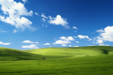 Fototapeta premium A beautiful summer or spring landscape with green grass on the hills and green fields. The blue sky is filled with white clouds and bright sunlight. Nature as a background.