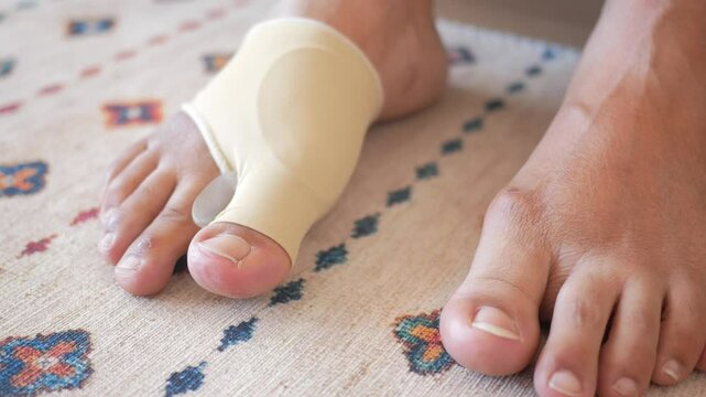 Experience comfort by wearing a Bunion Corrector on your foot as you walk on the carpet