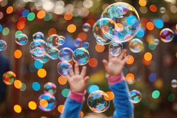 Papier peint photo intissé Soap bubbles are flying, the child is happy on the street.