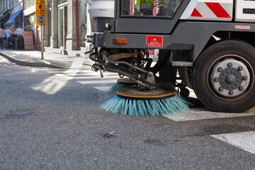 cleaning city street, closeup of brush of a street sweeper vehicle © Song_about_summer
