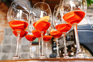 glasses of red cocktails on the bar. refreshing light alcoholic drinks for the party. aperol