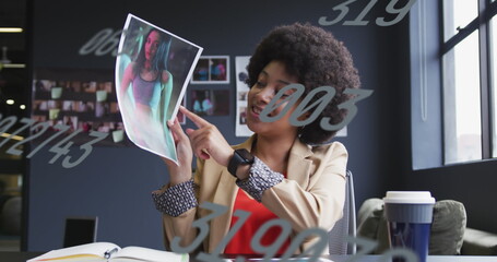 Image of data processing over african american businesswoman in office