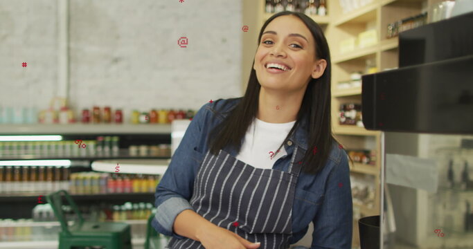 Image of icons over biracial female shop assistant smiling