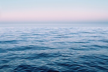 Obraz premium Large body of water with hint of lavender under a vibrant sky, A tranquil sea of light blue with hints of lavender undertones