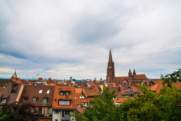 Germany, Freiburg im Breisgau aerial view above old town houses, roofs and historical muenster cathedral building